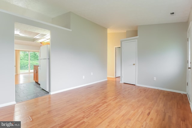 spare room featuring light hardwood / wood-style flooring