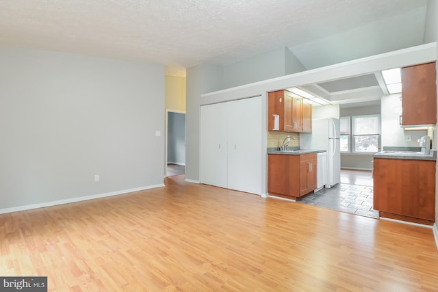 408 Berkshire Ct, Joppa, MD 21085 - unfurnished living room with light wood finished floors and a textured ceiling