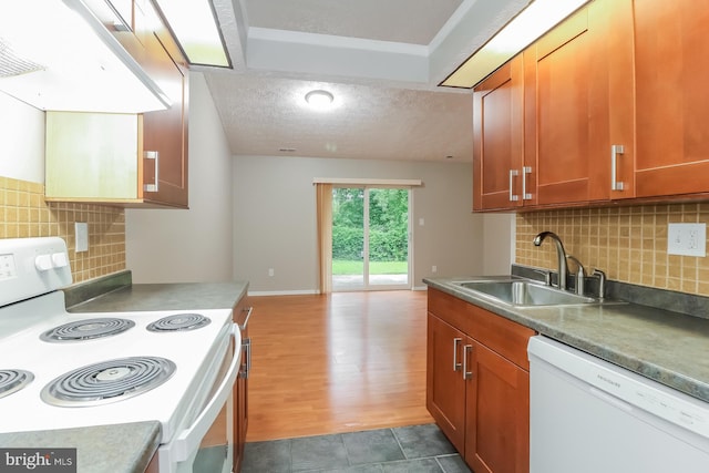 408 Berkshire Ct, Joppa, MD 21085 - kitchen featuring white appliances, brown cabinetry, backsplash, premium range hood, and a textured ceiling