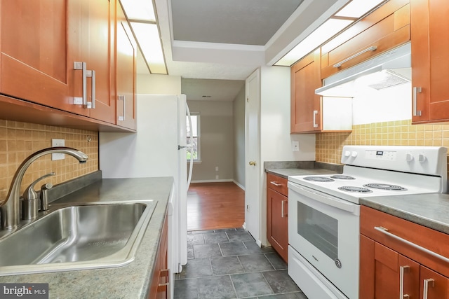 408 Berkshire Ct, Joppa, MD 21085 - kitchen with electric stove, under cabinet range hood, decorative backsplash, and brown cabinets