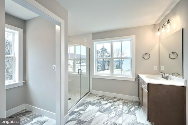 bathroom with a shower with door and vanity