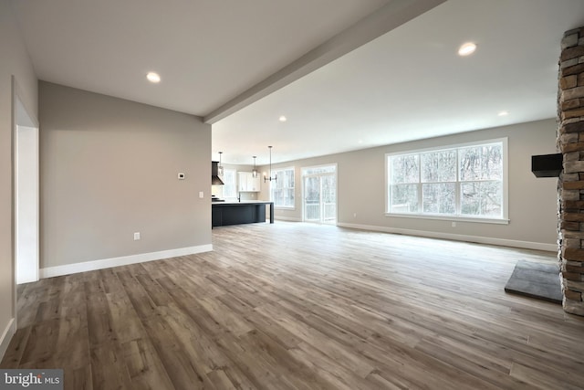 unfurnished living room featuring a fireplace and wood-type flooring