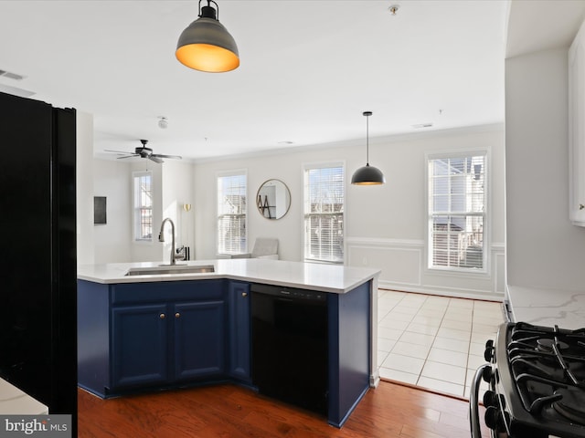 kitchen featuring sink, dark hardwood / wood-style floors, blue cabinets, black appliances, and ornamental molding