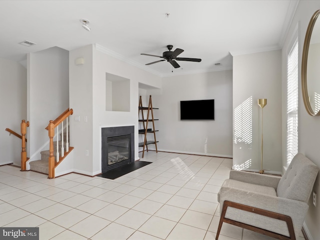 living room with crown molding, ceiling fan, and light tile patterned flooring