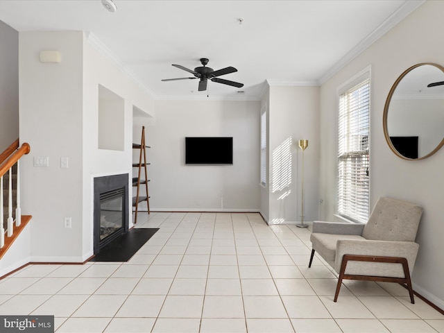 tiled living room featuring ceiling fan and ornamental molding