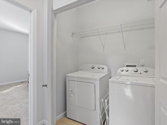 laundry room featuring washer and dryer and light carpet