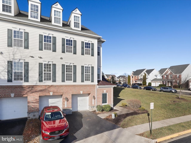 view of front of home with a front yard and a garage