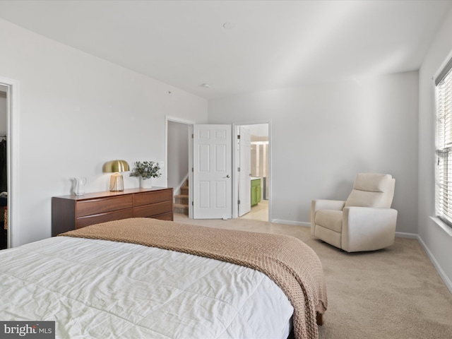 carpeted bedroom featuring ensuite bathroom