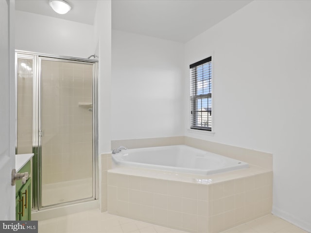 bathroom with tile patterned floors and shower with separate bathtub