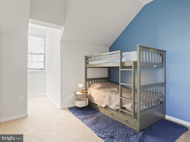 bedroom featuring carpet flooring and vaulted ceiling