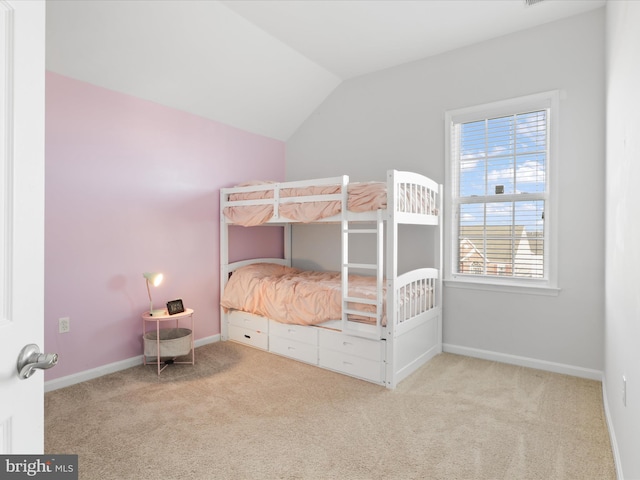 unfurnished bedroom featuring light colored carpet and lofted ceiling