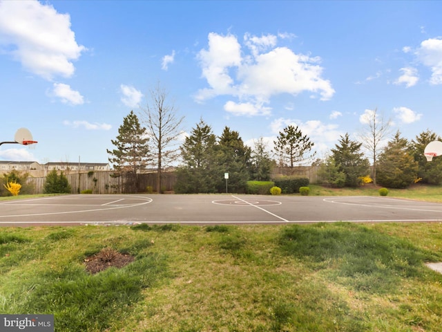 view of basketball court with a lawn