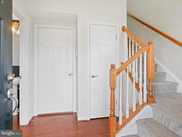 stairway with hardwood / wood-style flooring