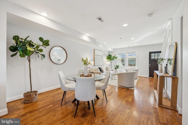 dining room with recessed lighting, visible vents, baseboards, and wood finished floors