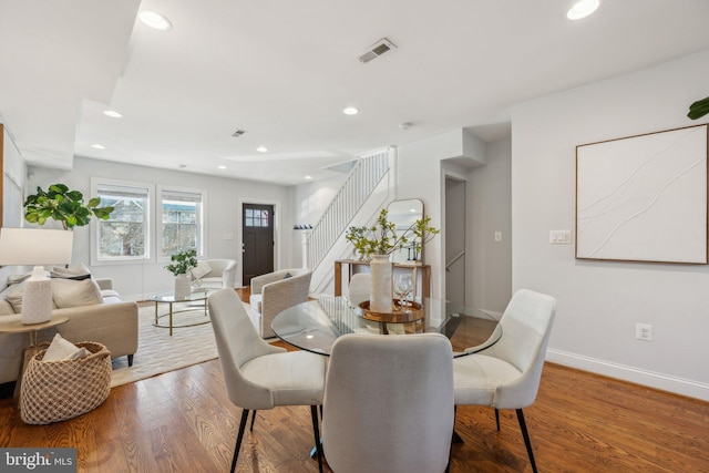 dining area with stairway, wood finished floors, visible vents, baseboards, and recessed lighting