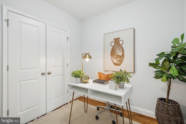 office space featuring baseboards and wood finished floors