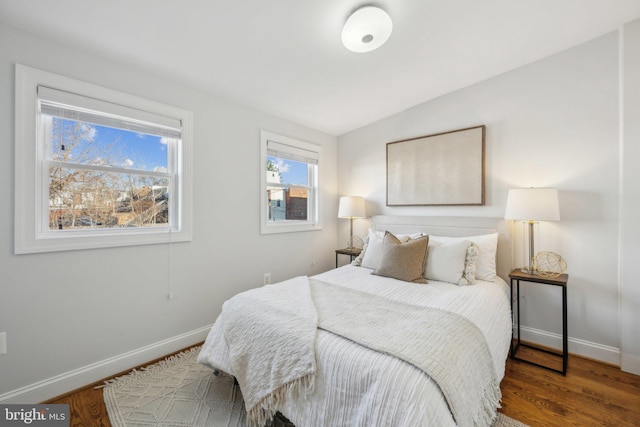 bedroom with baseboards and wood finished floors