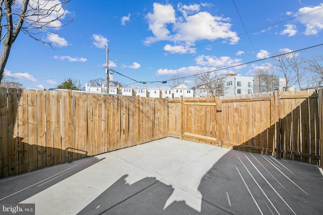 exterior space with a patio area, fence, and a residential view