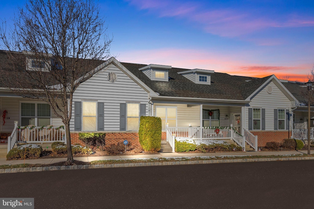 cape cod home with covered porch