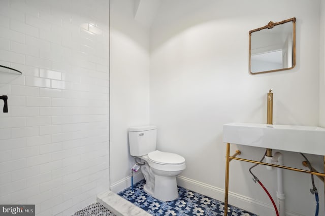 bathroom featuring tile patterned floors, sink, and toilet