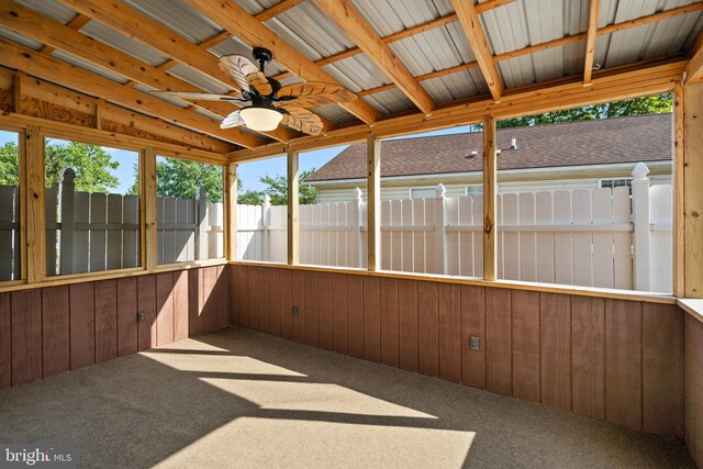 unfurnished sunroom featuring ceiling fan