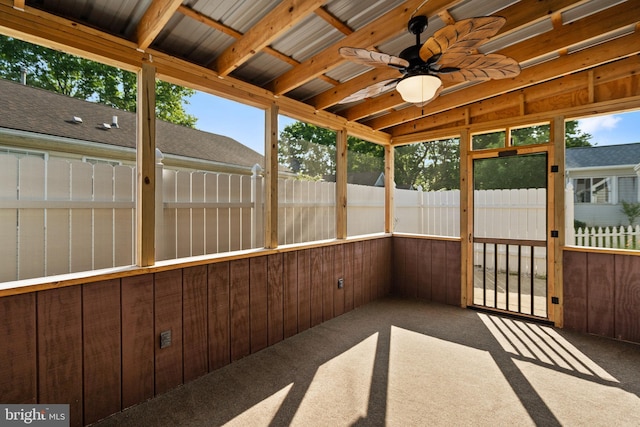 unfurnished sunroom featuring ceiling fan