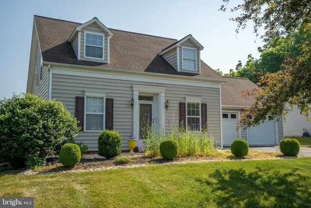 cape cod-style house with a garage and a front lawn