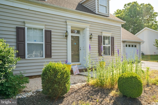 view of exterior entry with a garage