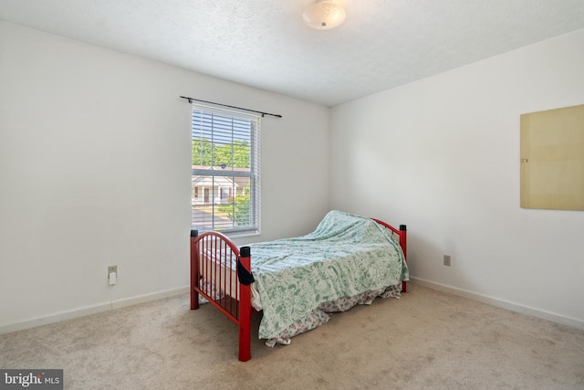 carpeted bedroom featuring a textured ceiling