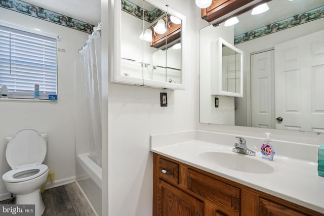 full bathroom with vanity, wood-type flooring, shower / bath combo, and toilet