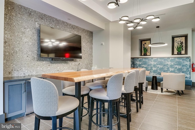 tiled dining space featuring indoor bar