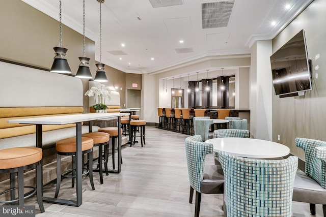 dining space featuring crown molding