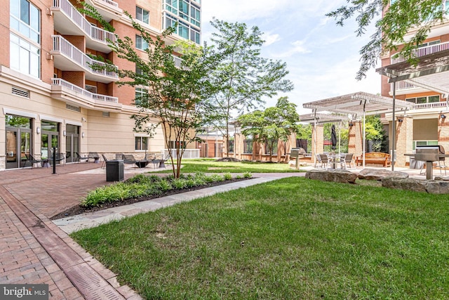 view of home's community featuring a pergola, a lawn, and a patio