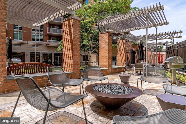 view of patio featuring area for grilling, a pergola, and an outdoor fire pit