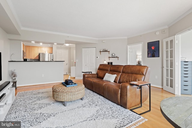 living room with crown molding and light hardwood / wood-style floors