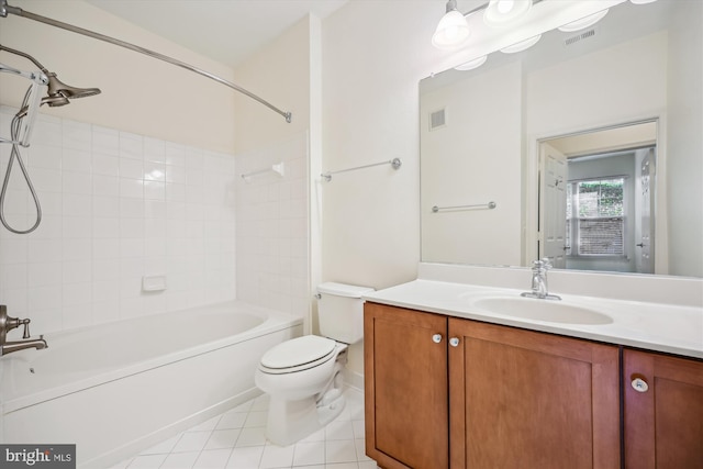 full bathroom featuring tile patterned flooring, vanity, toilet, and tiled shower / bath