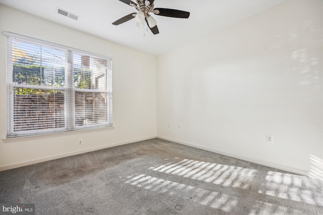 carpeted spare room with ceiling fan