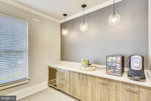 kitchen with decorative light fixtures, light stone countertops, ornamental molding, and light brown cabinetry