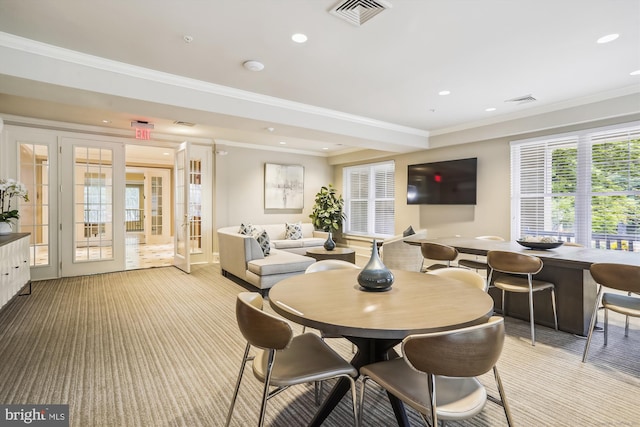 carpeted dining area with ornamental molding