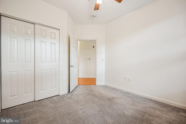 unfurnished bedroom with light carpet, a closet, and ceiling fan