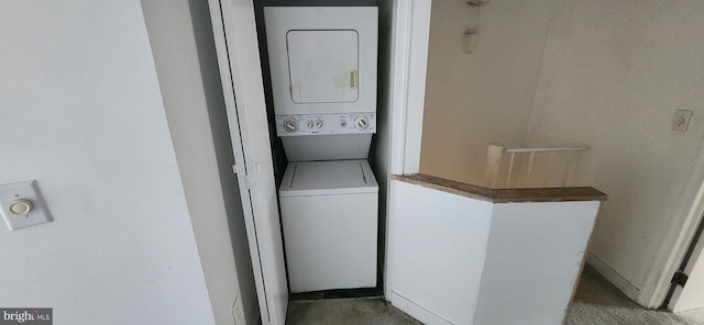 washroom with stacked washer / drying machine