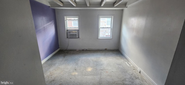 carpeted empty room featuring beam ceiling and cooling unit