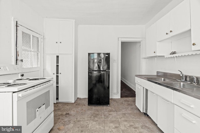 kitchen featuring white electric range oven, black fridge, white cabinetry, and sink