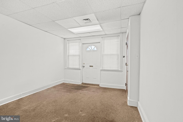 carpeted entryway with a drop ceiling