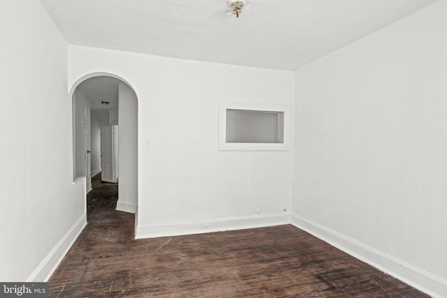 unfurnished room featuring dark hardwood / wood-style flooring