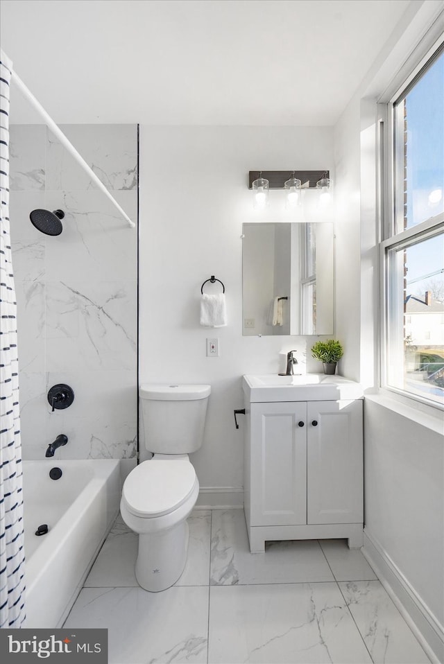 full bathroom featuring vanity, a healthy amount of sunlight, tiled shower / bath combo, and toilet