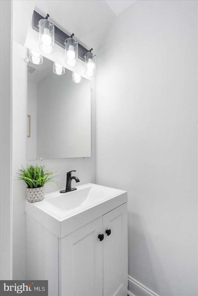 bathroom with vanity and vaulted ceiling