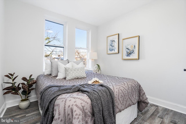 bedroom with dark wood-type flooring