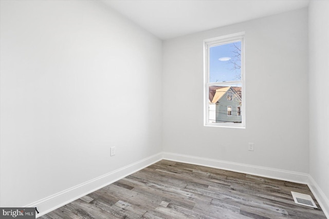 unfurnished room with hardwood / wood-style flooring