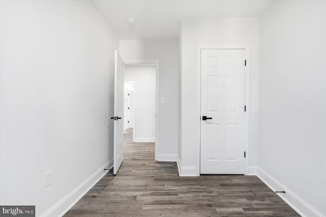 corridor with dark wood-type flooring